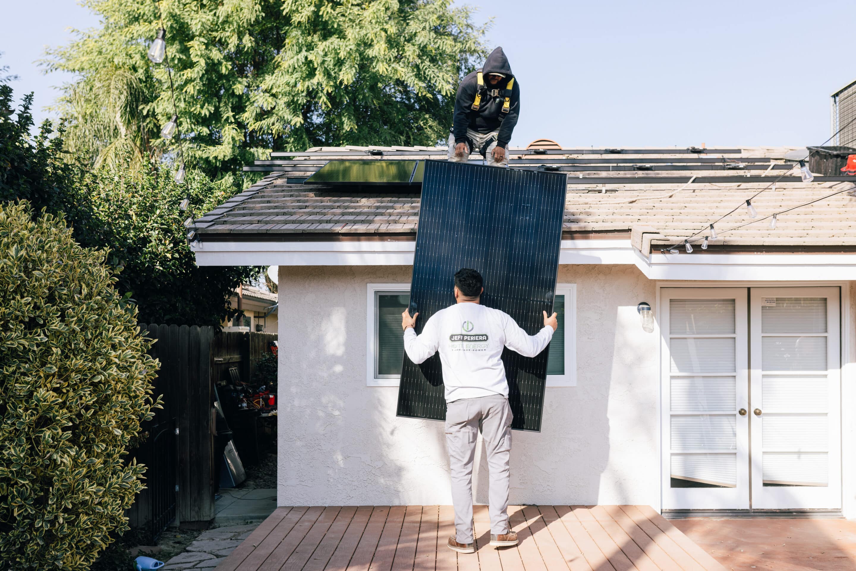 solar installers on a roof